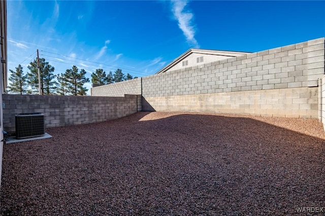 view of yard with cooling unit and a fenced backyard