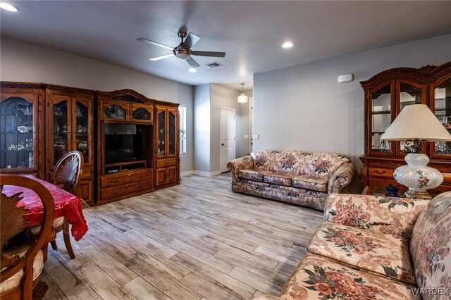 living area with recessed lighting, visible vents, ceiling fan, and light wood finished floors