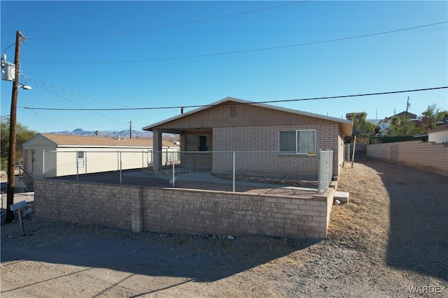 exterior space with a fenced backyard and brick siding