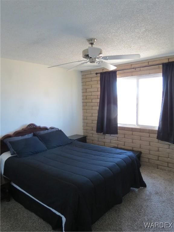 bedroom featuring ceiling fan, a textured ceiling, and carpet flooring