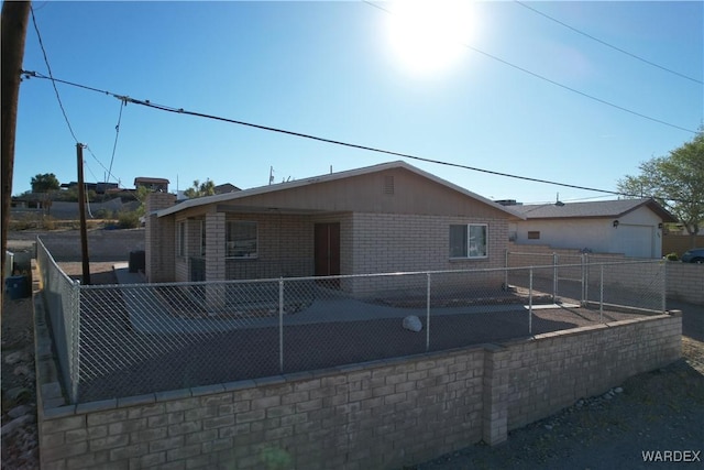 view of front of property featuring fence and brick siding