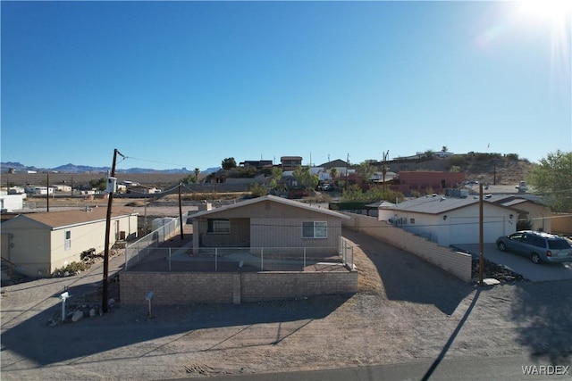 view of front facade featuring a residential view and fence