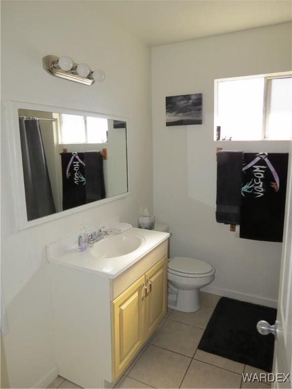 full bathroom with toilet, tile patterned flooring, and vanity