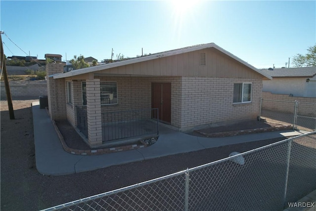 view of front of house with brick siding and fence