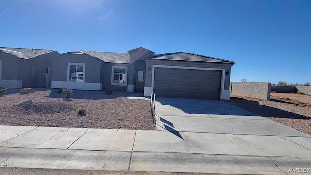 ranch-style home featuring driveway, a tile roof, an attached garage, fence, and stucco siding