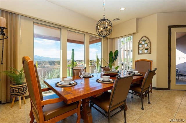 dining area with light tile patterned floors, a mountain view, recessed lighting, a notable chandelier, and visible vents