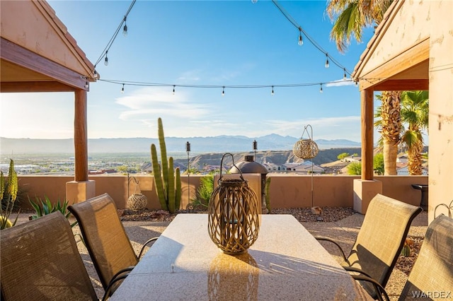 view of patio / terrace featuring outdoor dining area and a mountain view