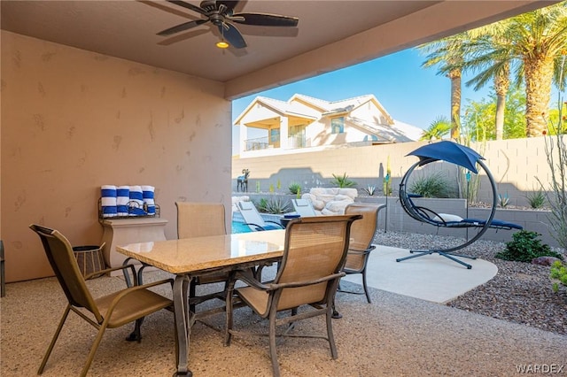 view of patio featuring a ceiling fan, outdoor dining space, and a fenced backyard