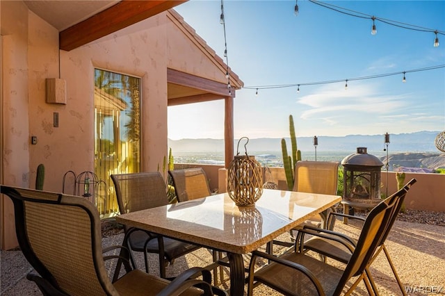 view of patio with outdoor dining space and a mountain view