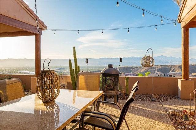 view of patio with outdoor dining space and a mountain view