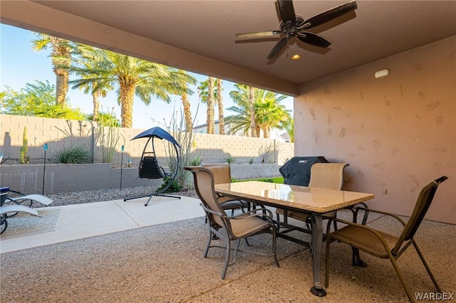 view of patio with ceiling fan, outdoor dining area, and a fenced backyard