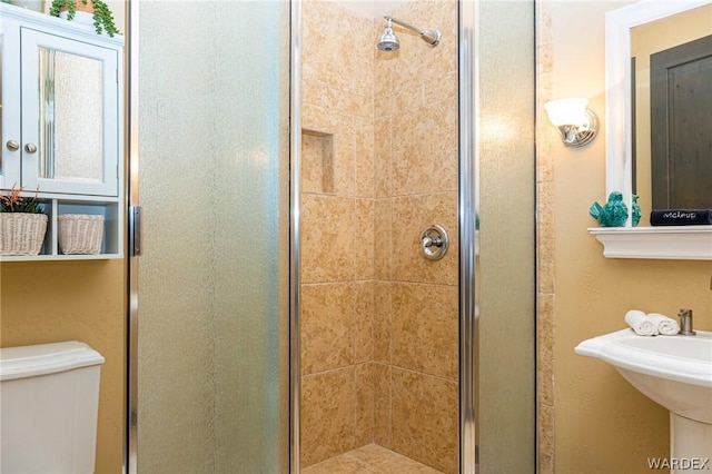 full bathroom with a stall shower and toilet