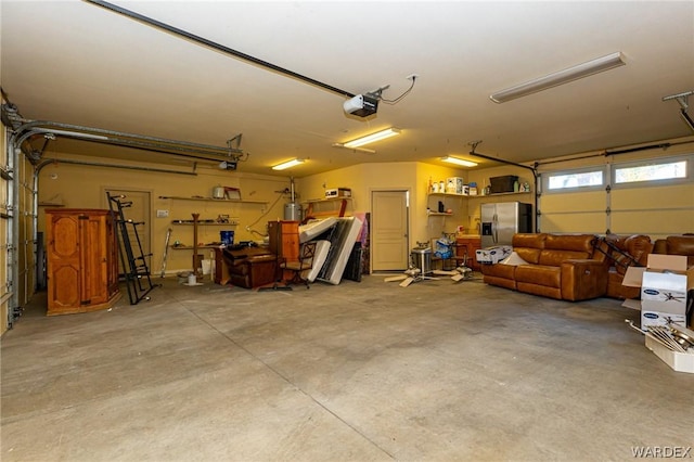 garage featuring stainless steel refrigerator with ice dispenser and a garage door opener