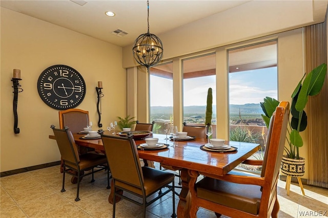 dining area with a mountain view, recessed lighting, visible vents, baseboards, and an inviting chandelier