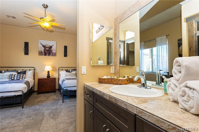 bathroom featuring a ceiling fan, visible vents, vanity, and ensuite bath