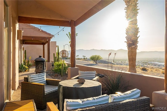 view of patio / terrace with a balcony and a mountain view