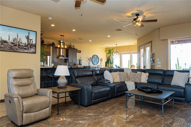 living area with recessed lighting, marble finish floor, and ceiling fan