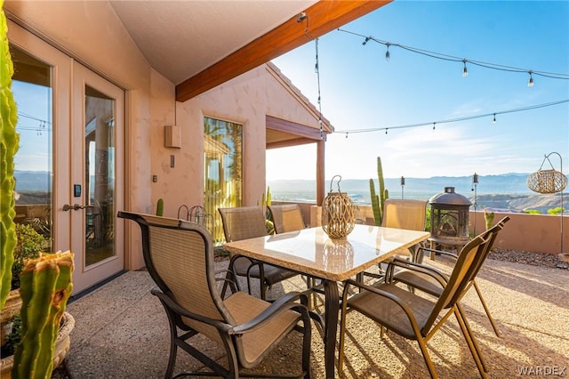 view of patio / terrace featuring outdoor dining space and a water and mountain view