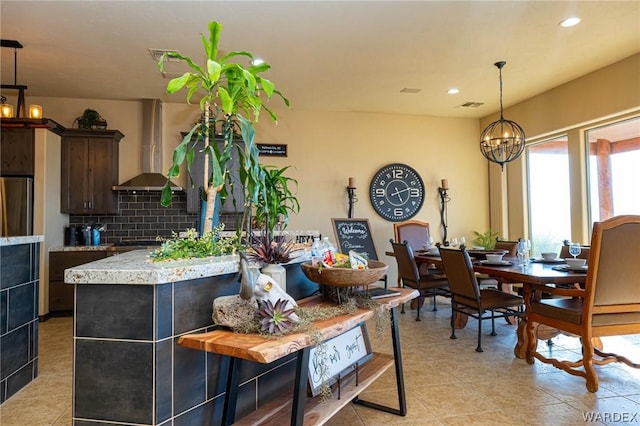 dining space with a notable chandelier, light tile patterned floors, visible vents, and recessed lighting