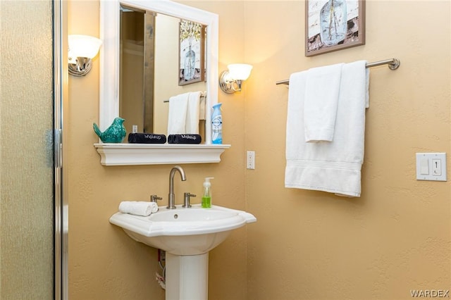 full bathroom with a sink and an enclosed shower