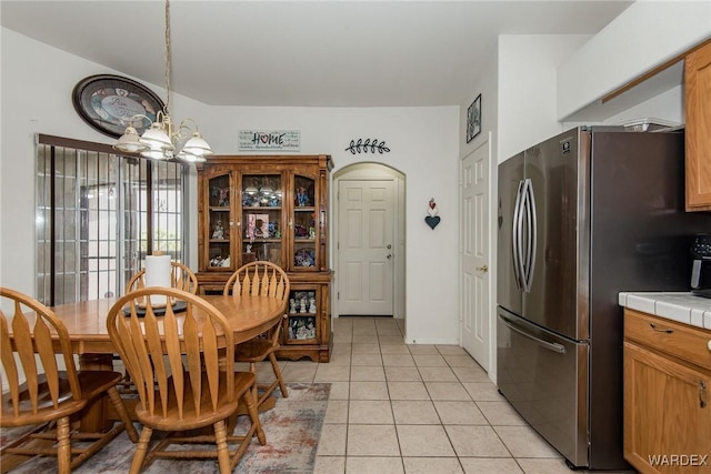 2355 Morningside Dr, Bullhead City, AZ 86442 - dining area featuring light tile patterned floors and a chandelier