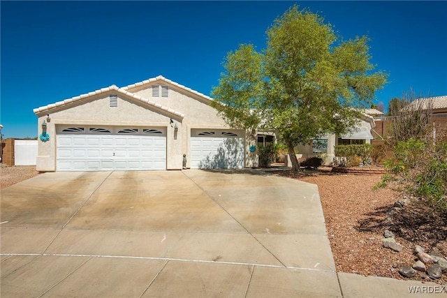 2355 Morningside Dr, Bullhead City, AZ 86442 - view of front of property featuring stucco siding, a tiled roof, concrete driveway, and an attached garage