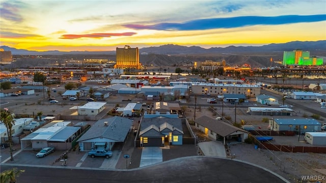 aerial view at dusk with a city view and a mountain view