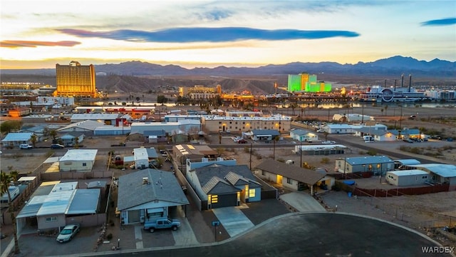 drone / aerial view with a residential view, a mountain view, and a view of city