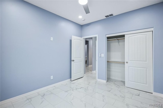 unfurnished bedroom with marble finish floor, baseboards, visible vents, and a closet