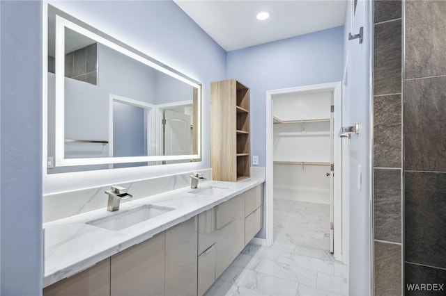 full bath featuring recessed lighting, marble finish floor, a sink, and double vanity