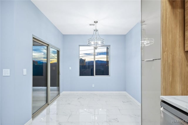 unfurnished dining area featuring a chandelier, marble finish floor, visible vents, and baseboards