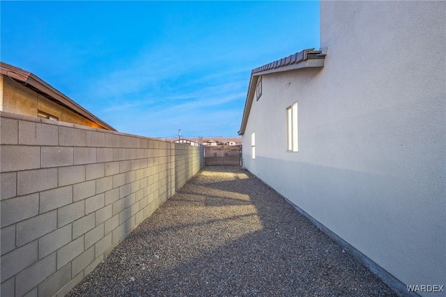 view of home's exterior with a fenced backyard and stucco siding