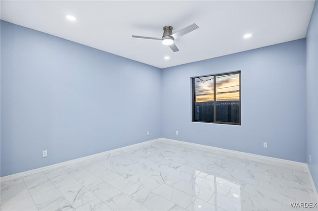 empty room with recessed lighting, marble finish floor, ceiling fan, and baseboards