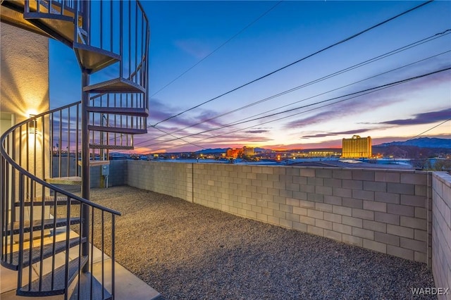 yard at dusk featuring stairway