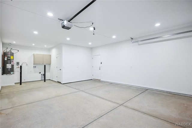 garage featuring a garage door opener, recessed lighting, and water heater