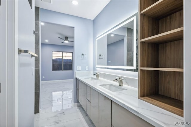 bathroom featuring ceiling fan, marble finish floor, double vanity, and a sink