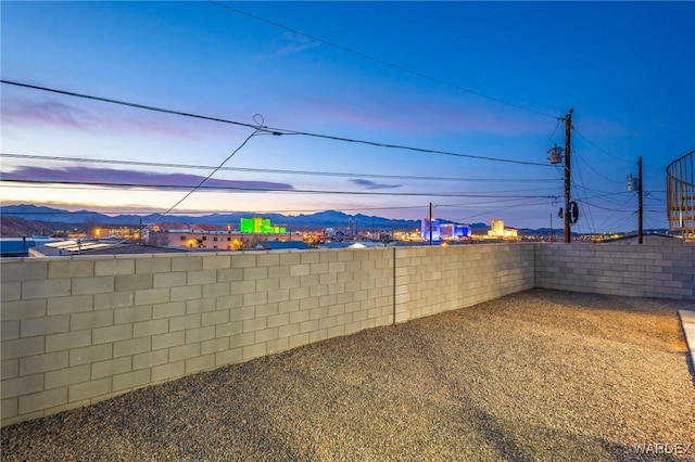 view of yard with a fenced backyard and a mountain view