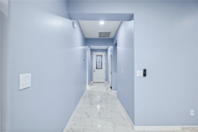 corridor featuring marble finish floor, visible vents, and baseboards