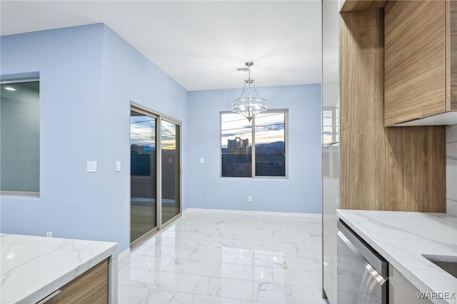 kitchen featuring light stone counters, baseboards, marble finish floor, hanging light fixtures, and an inviting chandelier