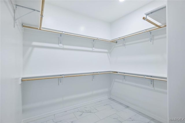 spacious closet featuring marble finish floor