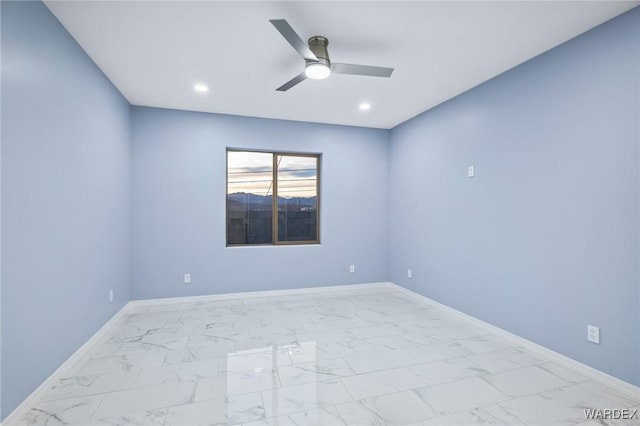 empty room with ceiling fan, marble finish floor, recessed lighting, and baseboards