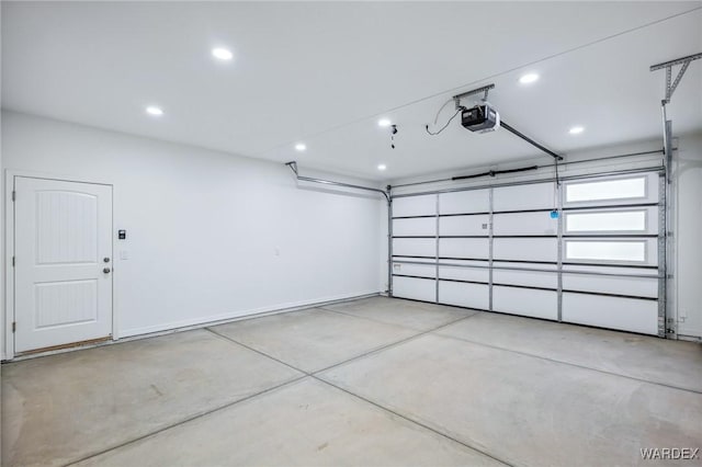 garage with a garage door opener, recessed lighting, and baseboards