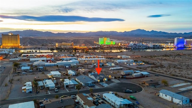 aerial view at dusk featuring a mountain view