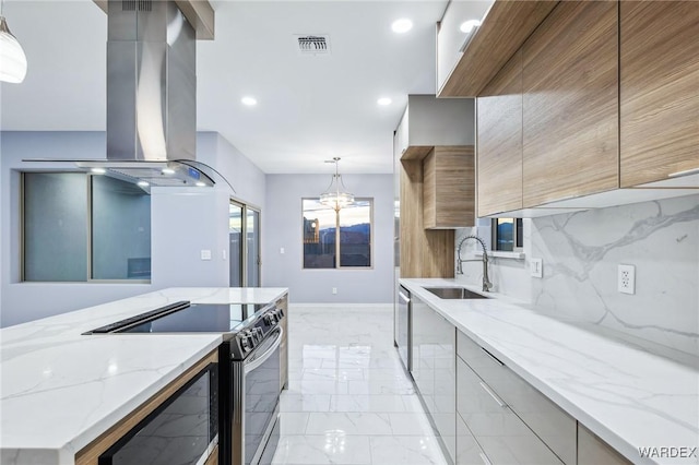 kitchen featuring appliances with stainless steel finishes, island exhaust hood, hanging light fixtures, and modern cabinets