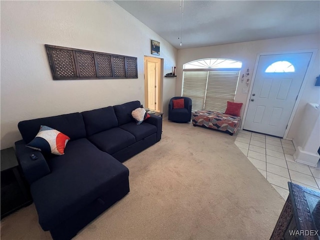living room with baseboards, tile patterned flooring, and carpet flooring