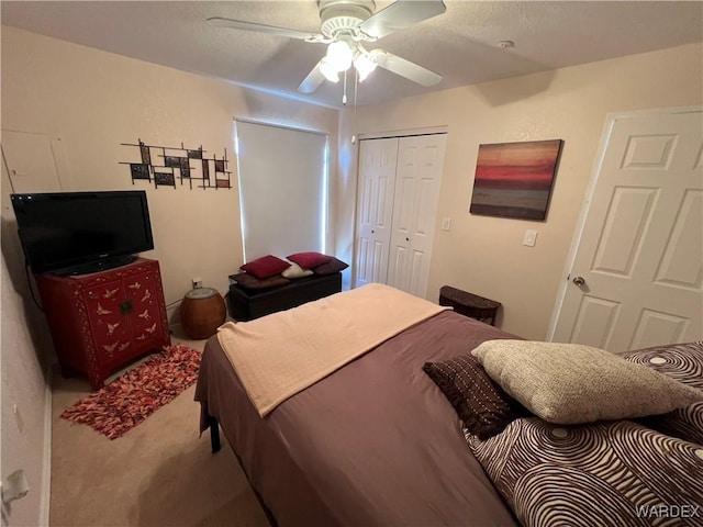 bedroom with a closet, ceiling fan, and carpet flooring