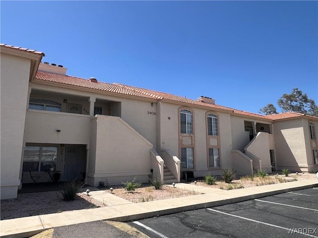 view of property featuring uncovered parking