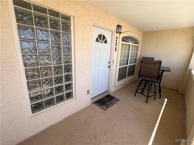 doorway to property with stucco siding