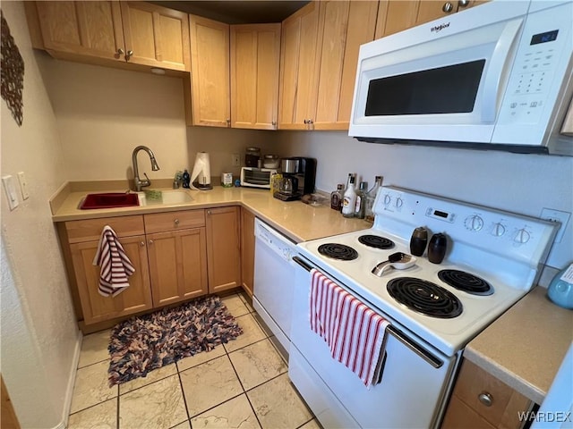 kitchen featuring a sink, white appliances, and light countertops