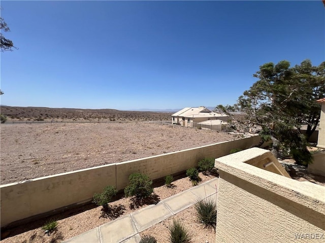 view of yard with fence and a mountain view